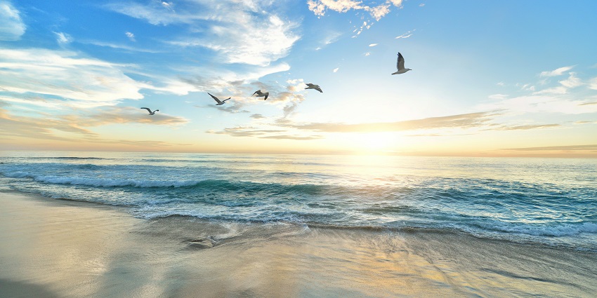 A breathtaking vista of glistening blue waters and pristine golden sands of Cua Dai Beach.