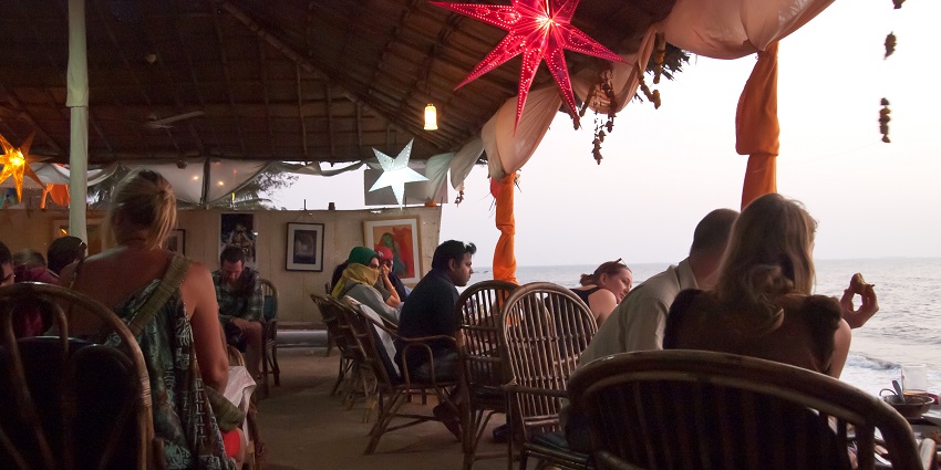 People enjoying at a beach shack near the Baga beach with scenic views of the sea