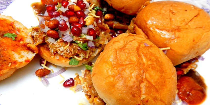 Spicy and sour Dabeli served with chutneys and pomegranate is one of the famous street foods in Surat.