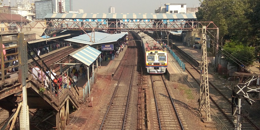 The busy Dadar Station showcasing colonial architecture and vibrant commuter activity.