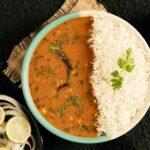 A bowl of dal makhani served with rice, one of the nest street food in Karol bagh