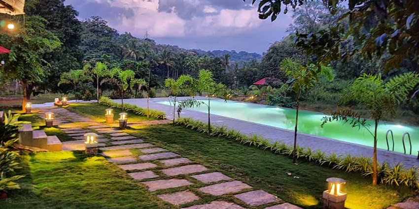 A picture of a resort near goa within 300 km, with well lit ambience during night time