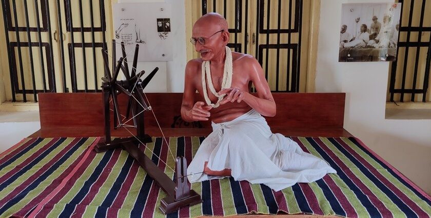 A breathtaking view of the statue of Mahatma Gandhi at dandi beach museum with a charkha.