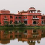 A side view of the Darbhanga Museum showcasing a pathway with plants on the side