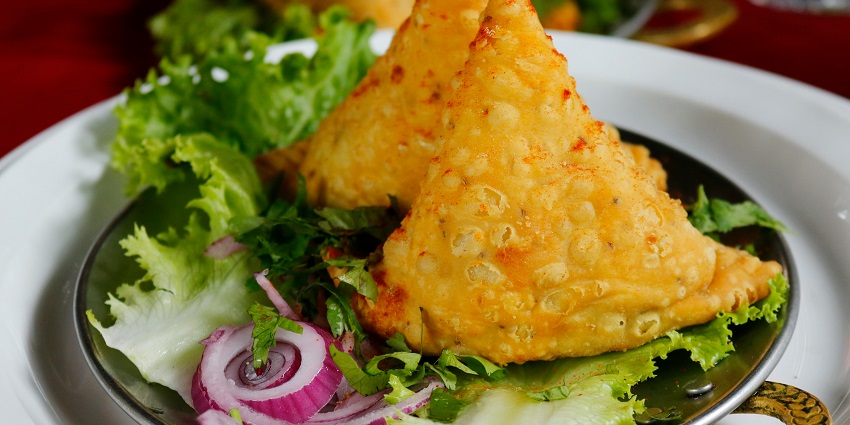 Close-up of fried food, including crispy items, served on a saucer with a simple presentation.