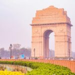 A breathtaking view of a brown monument surrounded by lush greenery during the day.