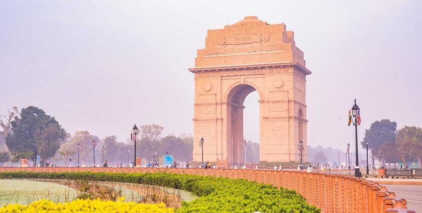 A breathtaking view of a brown monument surrounded by lush greenery during the day.