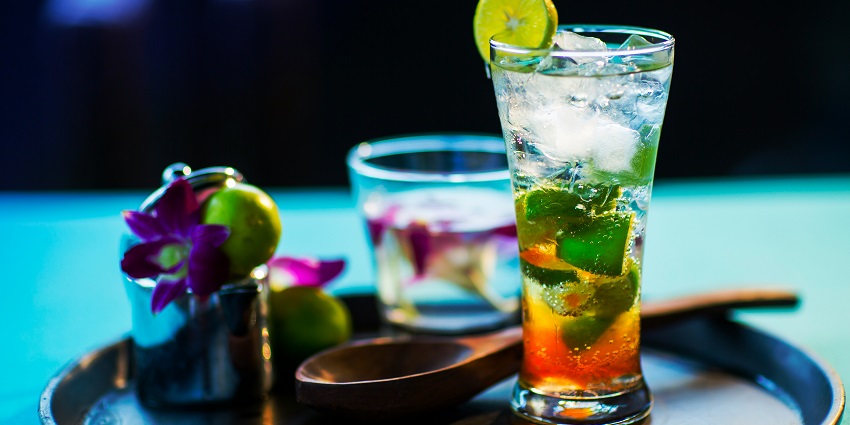 Lime sode glasses filled with ice cubes, served on a plate with beautiful decorations