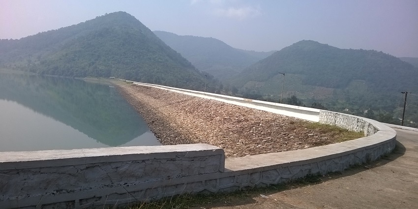 Way to the dam with a view of the water reservoir and surrounding hills in Odisha.