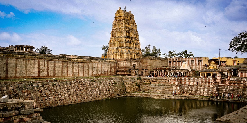 Scenic pond and temple tower, reflecting peaceful charm of things to do in Ranakpur.