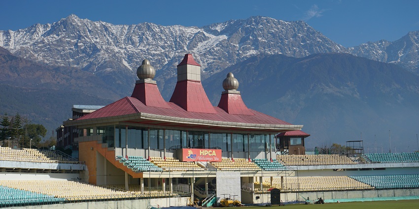 Image of Dharamshala cricket stadium against backdrop of snow covered mountains