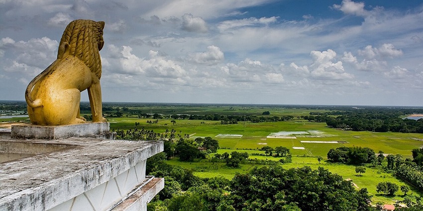 A statue of a lion, the king of the jungle, looks over the plains of Daya river from his perch atop the Dhauligiri hills