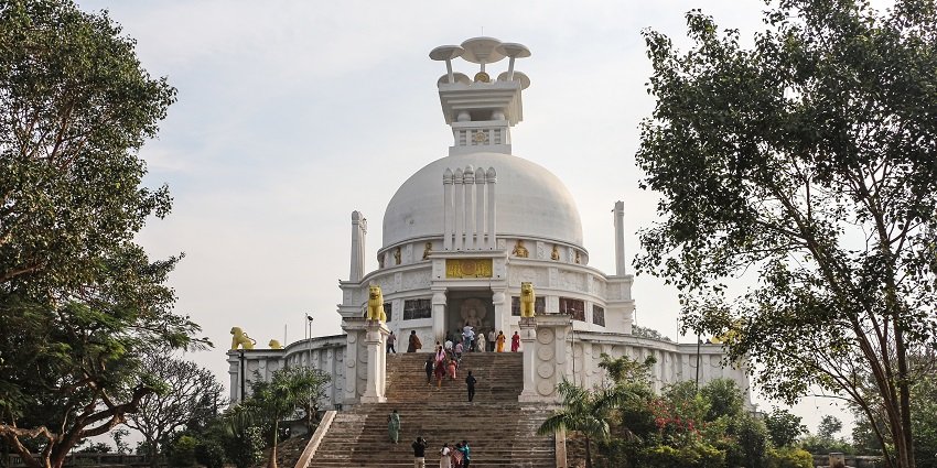 The view of the pristine white dome with golden lions at Shanti Stupa in Dhauli, Odisha.