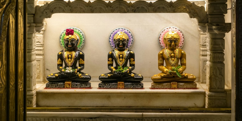 An image of beautiful idols of Jain Gods with intricate designs at a Jain temple in India.
