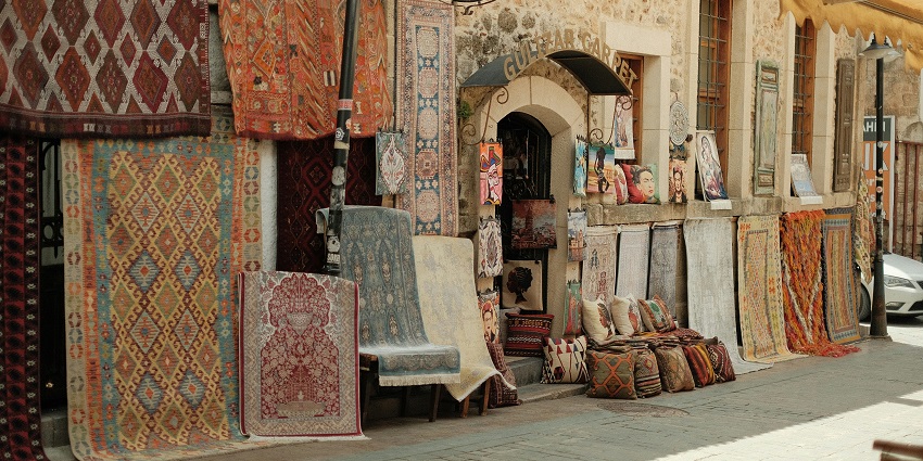 A glimpse of the famous Dilli Haat market featuring printed mats, cushions, and rugs.