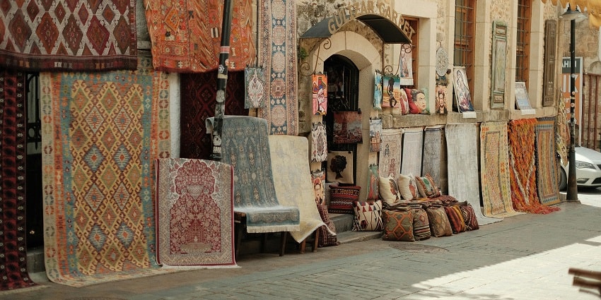 A glimpse of colourful carpets with traditional designs being sold at Dilli Haat.