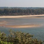 Beautiful panoramic image of a river merging into the ocean in Goa near the hill station