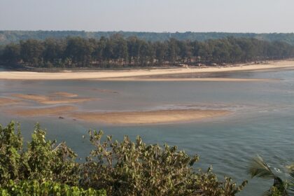 Beautiful panoramic image of a river merging into the ocean in Goa near the hill station