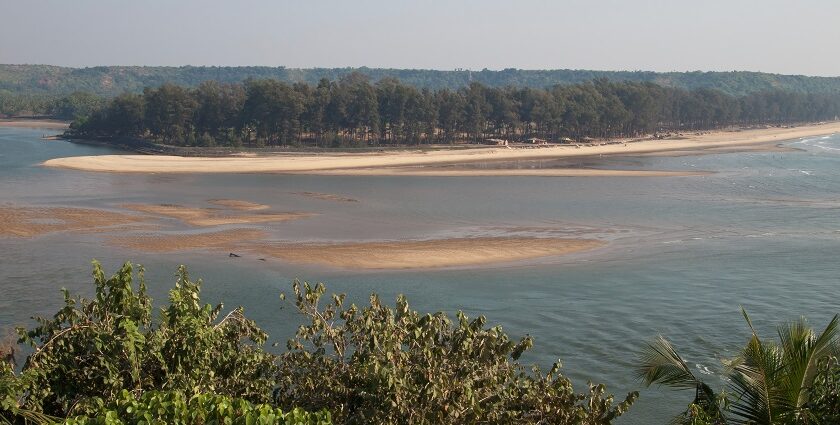 Beautiful panoramic image of a river merging into the ocean in Goa near the hill station