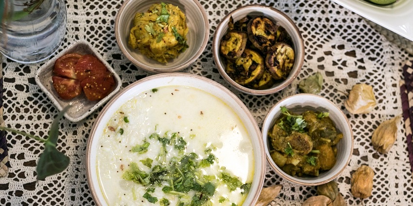Pakhala with assorted side dishes on the table of a restaurant in Odisha
