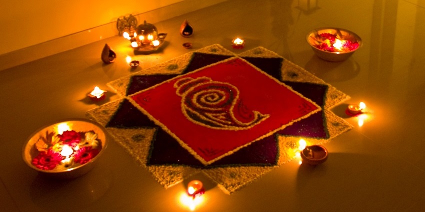 Diyas adorned around a beautiful rangoli, reflecting two of the significant rituals of Diwali
