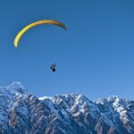 Experience Dobhi paragliding soaring over the lush green meadows of Himachal Pradesh.