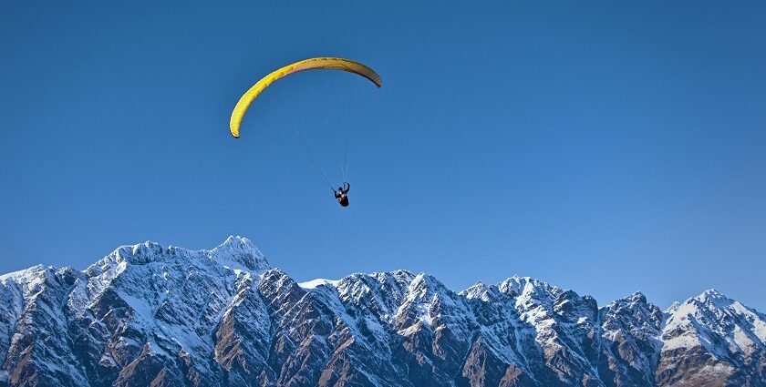 Experience Dobhi paragliding soaring over the lush green meadows of Himachal Pradesh.