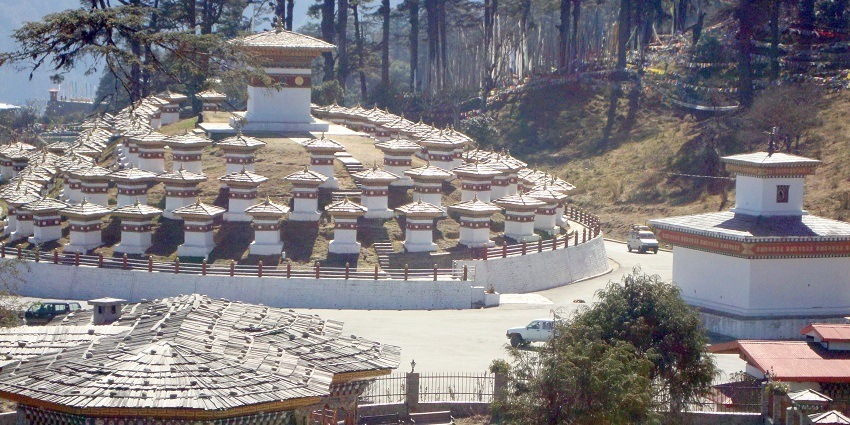 Dochula Pass in Bhutan features 108 chortens with views of the snow-capped Himalayas in the distance.