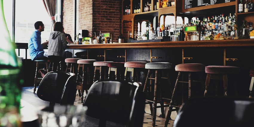 mage of a bar and restaurant where people talking and drinking and has beautiful ambience