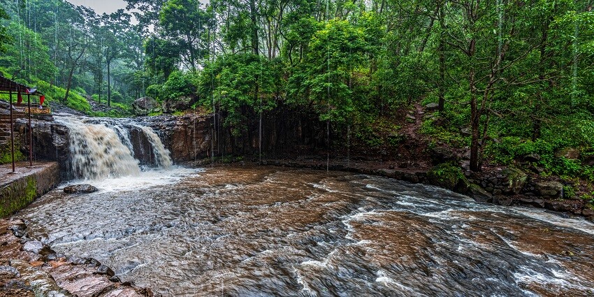 Dugdh Dhara Waterfalls in Amarkantak with cascading water and lush green surroundings.