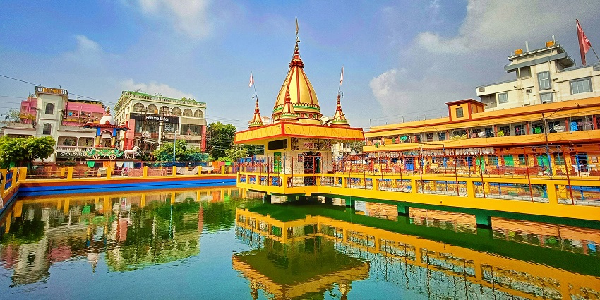 A view of Dudhadhari Math, surrounded by majestic temple domes and colourful flags.