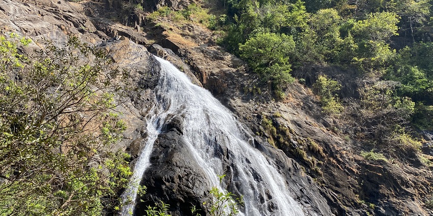 A picture of a waterfall slowly cascading down the rocky hill, one of the best places to visit near Goa within 50 km