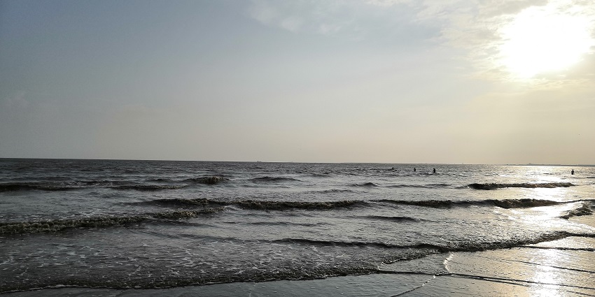 Visitors enjoying the lively atmosphere at Dumas Beach, one of the best beaches near Vadodara.
