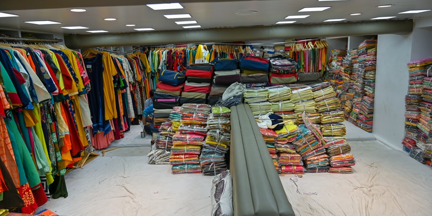 Display of different fabrics inside a shop at Dumas Road, one of the best shopping places in Surat