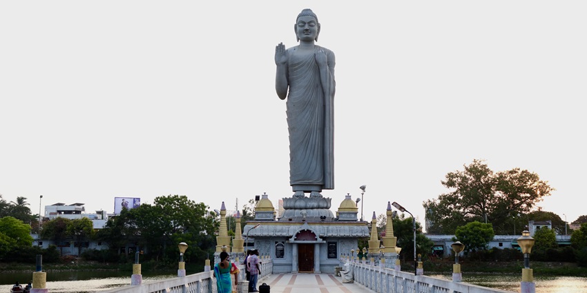 Buddha Park in Eluru featuring serene Buddha statue, green lawns, and shaded walkways