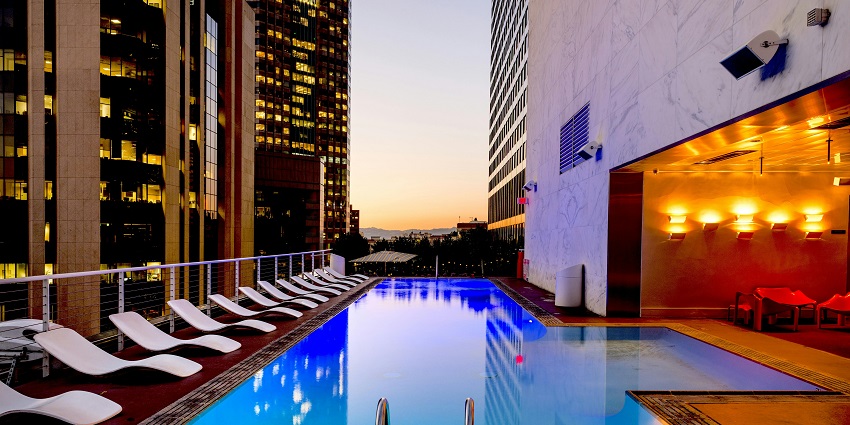 Luxurious poolside with white sun loungers, one of the great things to do in Jaipur for couples.
