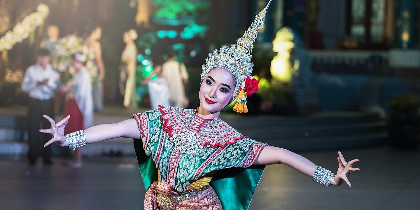 A dancer in elaborate costume performing Apsara dance during the Ramayana Festival in Siem Reap