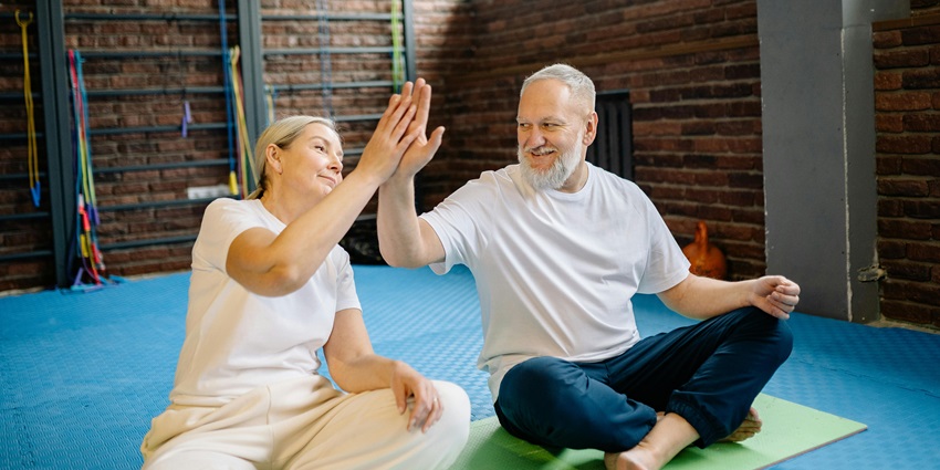 A picture of an aged couple engaging in yoga activities in Nepal