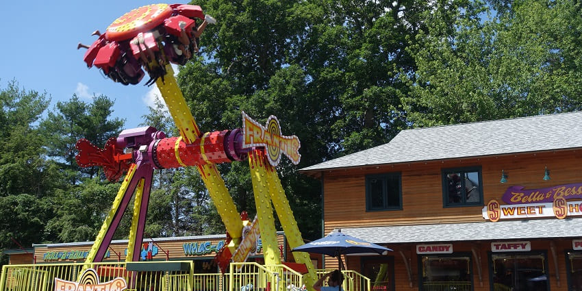 A picture of a thrilling ride in an amusement park with people screaming as they ride