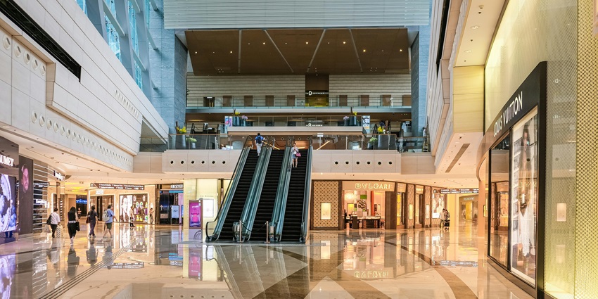A picture of a shopping mall in Vadodara with modern architecture and numerous stores