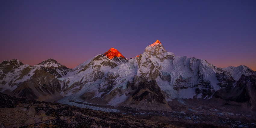 A breathtaking sunset view of Mount Everest, with the snow-covered peak bathed in golden light