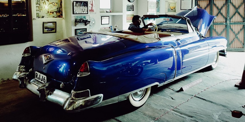 A picture of a vintage car parked in the garage of a heritage property in Neemrana