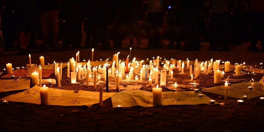 Lit candles arranged in a ritual pattern, creating a serene and spiritual atmosphere.