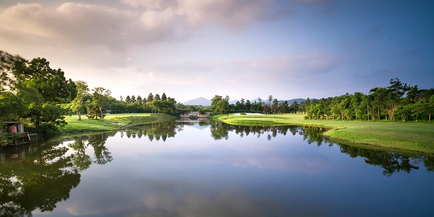 A glimpse of the Bhrigu Rishi Kund featuring serene waters and lush green vegetation.
