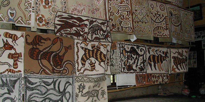 Interior view of a Tribal Art Gallery showcasing traditional tribal artwork and paintings