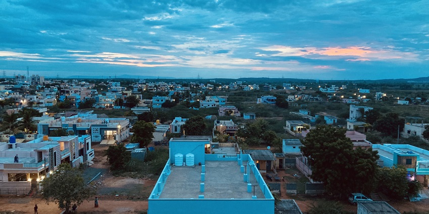 A picture of a peaceful town taken during the twilight hour with blue hues all around