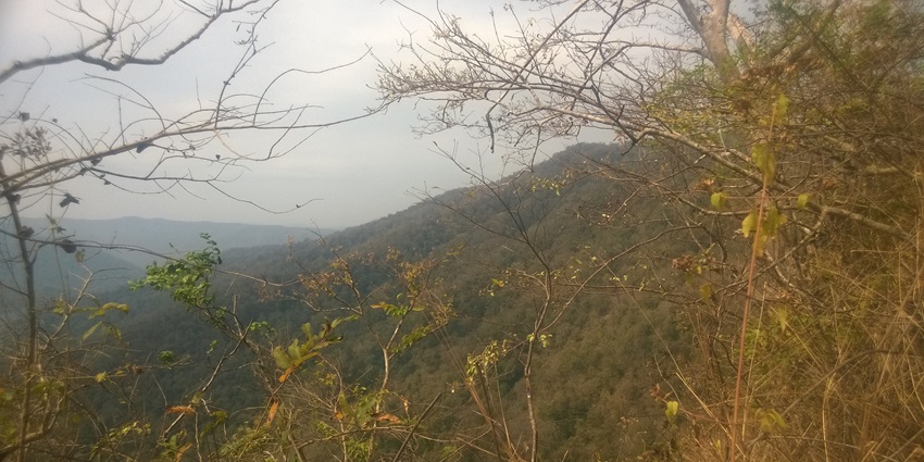 A mysterious limestone cave with a naturally formed Shiva Lingam, accessible through narrow tunnels and steep steps.