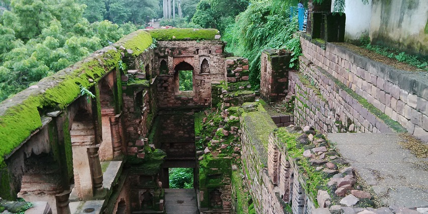 An inside view of Rani Kamlapati Palace, designed with intricate work and a beautiful lake.