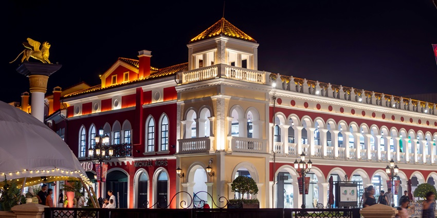 Clock tower building glowing at night, like the Kumbhalgarh Sound & Light Museum.