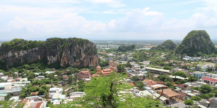 Exploring Marble Mountains near Da Nang is the best thing to do in Vietnam with rugged limestone peaks, lush greenery, and a clear sky